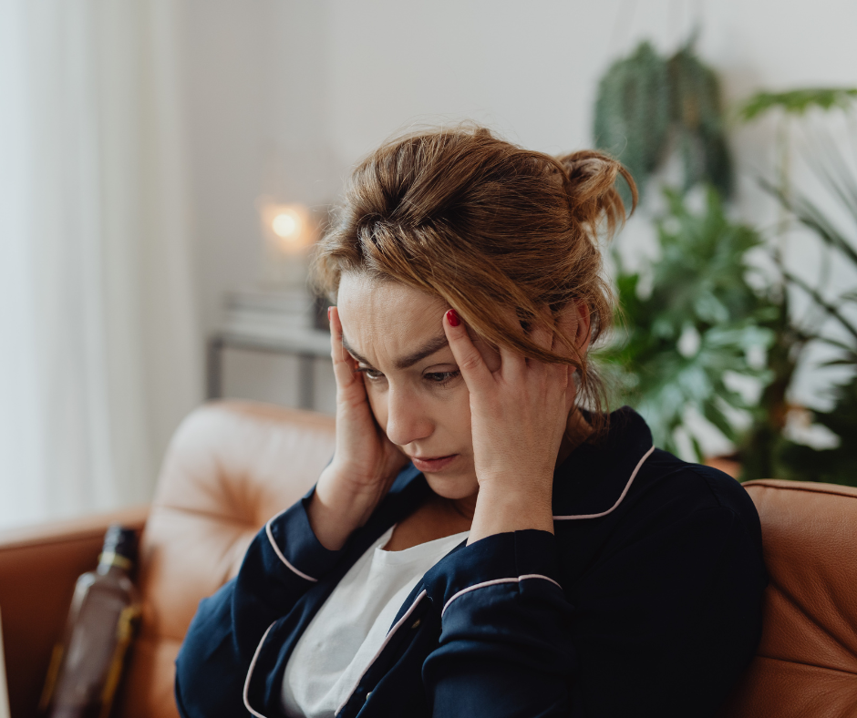 Woman sitting quietly and reflecting while learning about the connection between chronic stress, hormone health, weight management, and healthy aging.